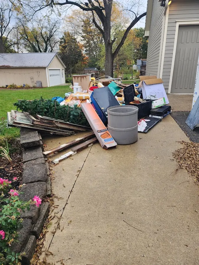 Dumpster being loaded with debris for 12 Yard Dumpster Rental in Arkadelphia
